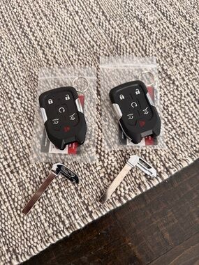 Set of 2 Six button car remotes. New in packaging.